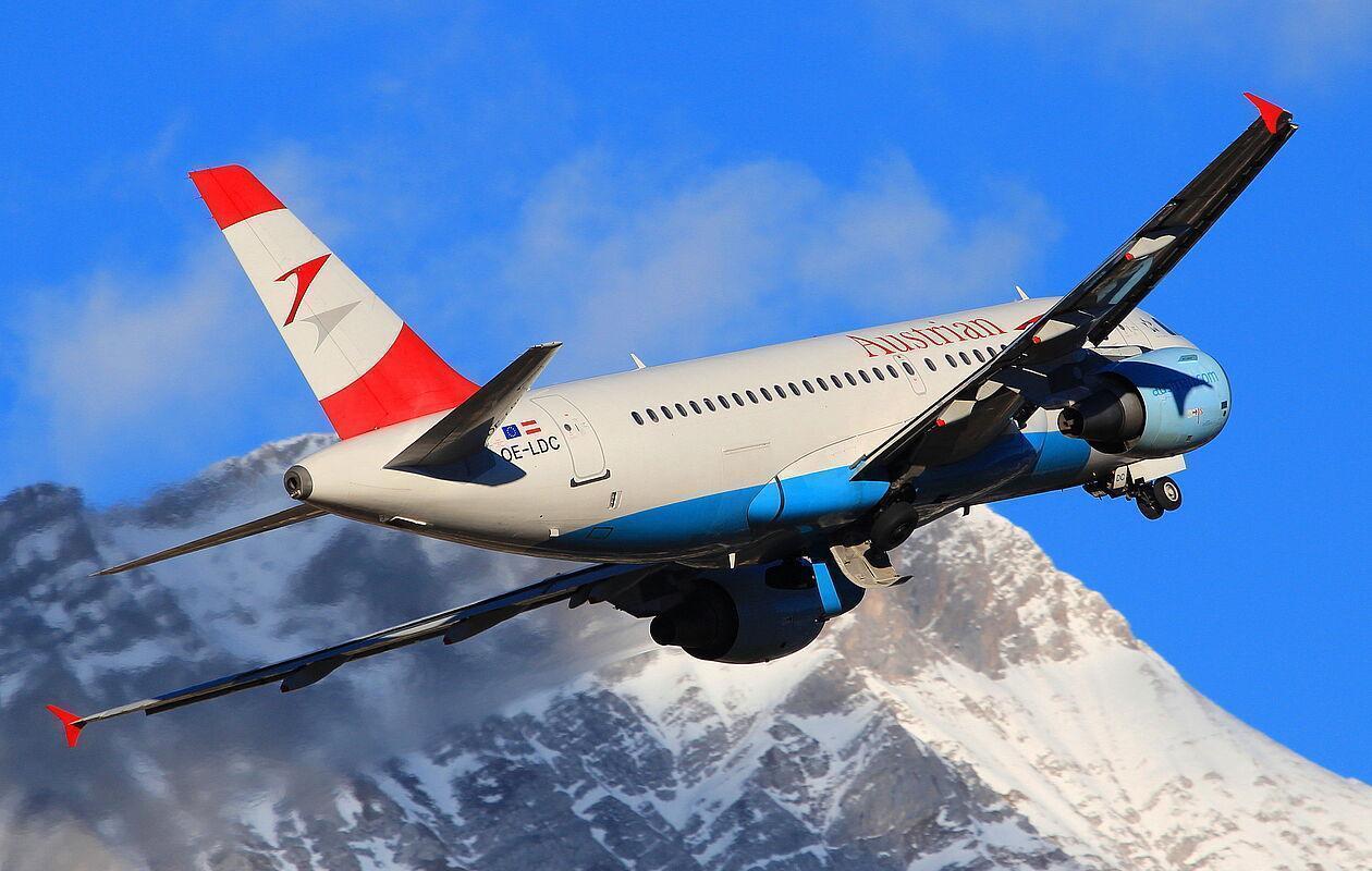 Ein Flugzeug der Austrian vor einer winterlichen Bergkulisse